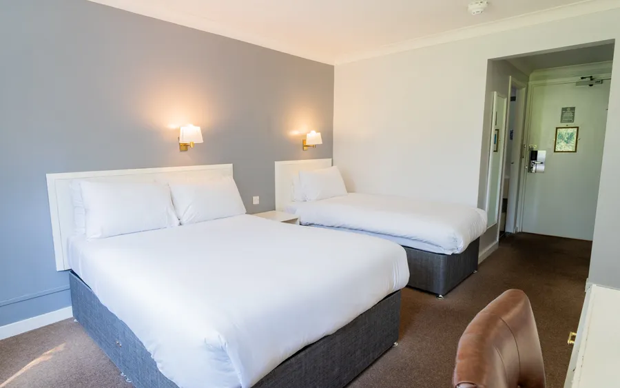 Room with two double beds at Sporting Lodge Inns