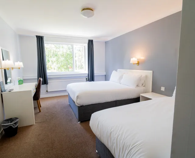 Room with two double beds at Sporting Lodge Inns