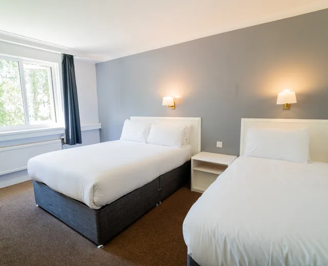 Room with two double beds at Sporting Lodge Inns
